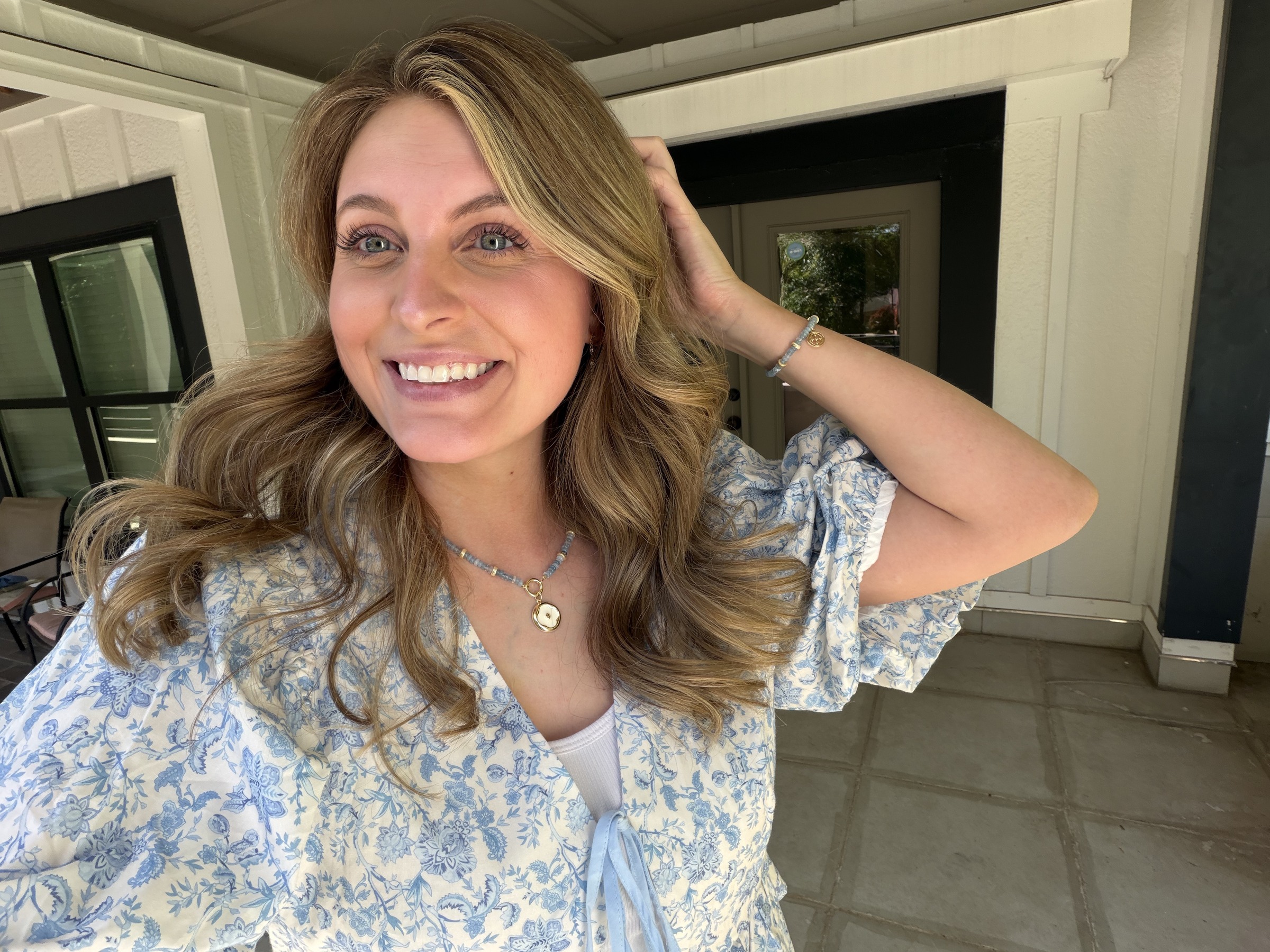 Tristin in a blue floral dress, soft natural light